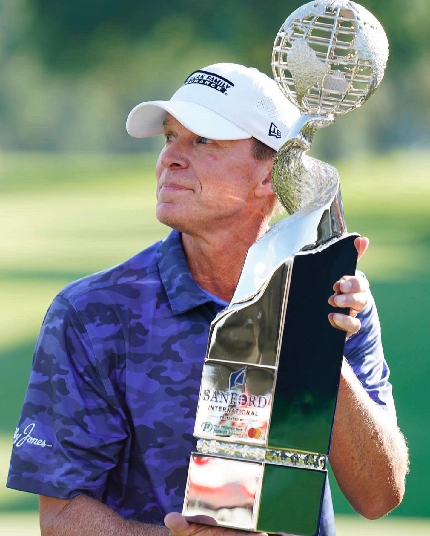 Sanford International Champion Steve Stricker holding redesigned trophy made by Malcolm DeMille